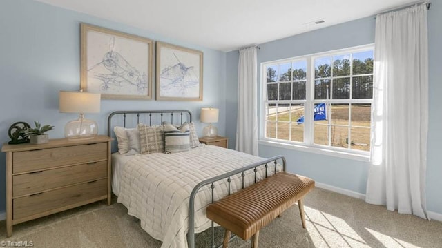 carpeted bedroom with visible vents and baseboards