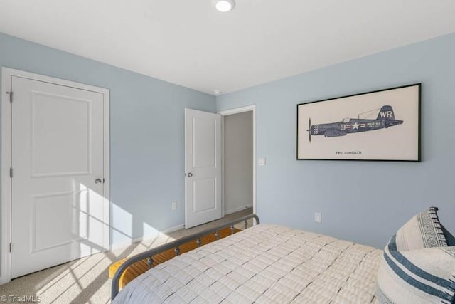 bedroom featuring baseboards and carpet