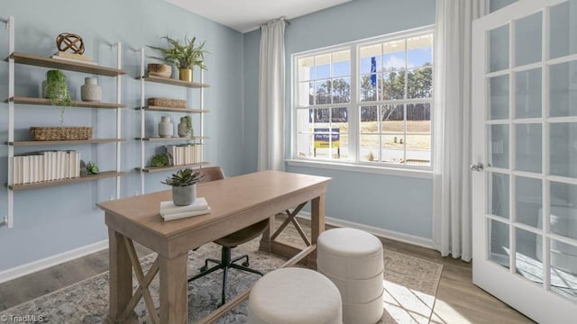 office space featuring baseboards and wood finished floors