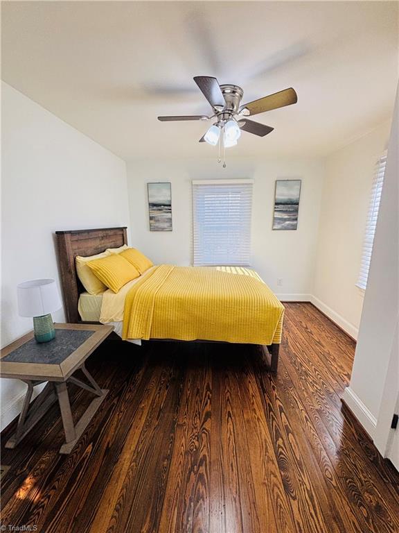 bedroom featuring ceiling fan and dark hardwood / wood-style floors