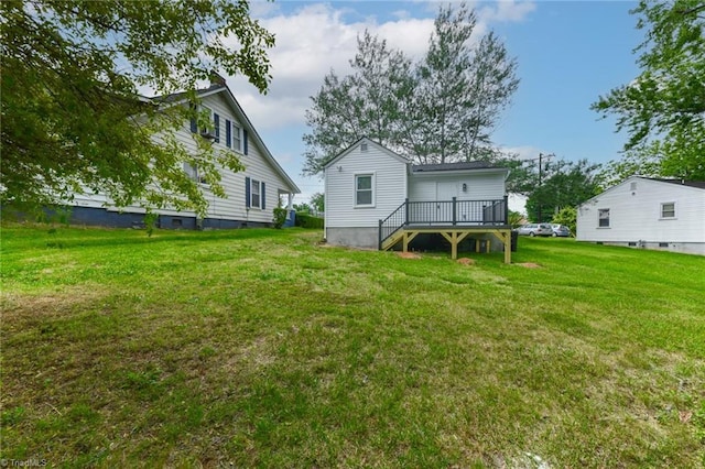 rear view of property with a lawn and a deck