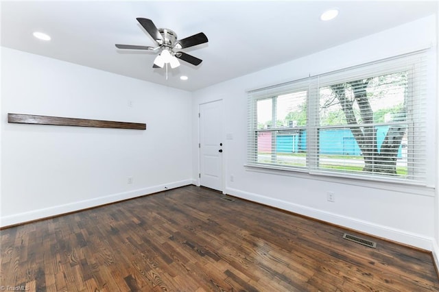 unfurnished room with ceiling fan and dark hardwood / wood-style flooring