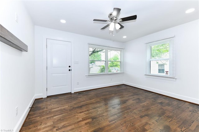 interior space with ceiling fan and dark hardwood / wood-style floors