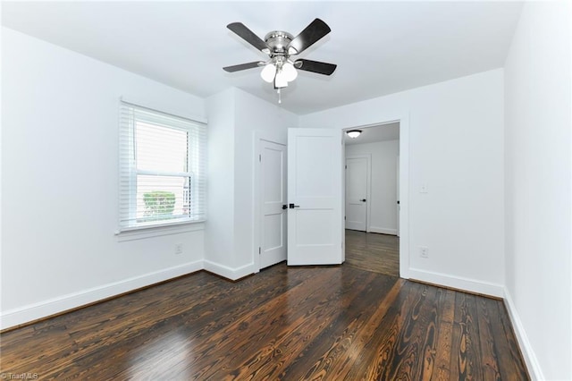 empty room featuring ceiling fan and dark wood-type flooring