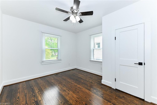 spare room featuring ceiling fan and dark hardwood / wood-style floors