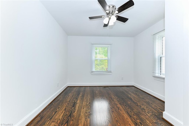 empty room with ceiling fan and dark hardwood / wood-style floors