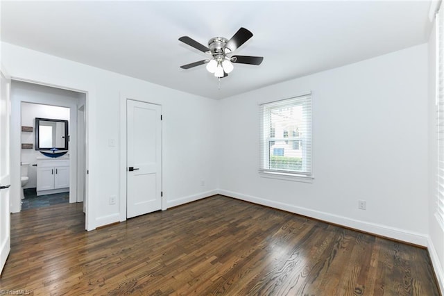 spare room with ceiling fan and dark wood-type flooring