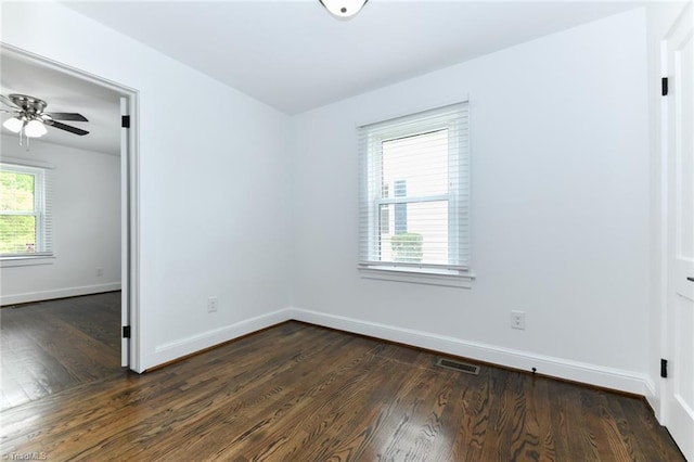 spare room with ceiling fan and dark wood-type flooring