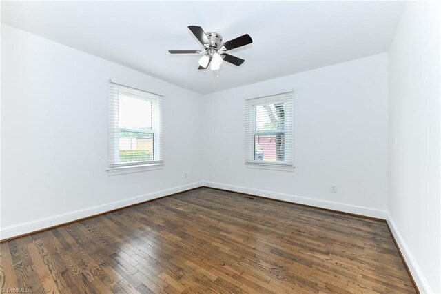 unfurnished room featuring ceiling fan and dark hardwood / wood-style floors