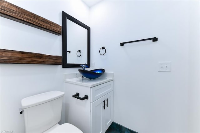 bathroom featuring toilet and vanity