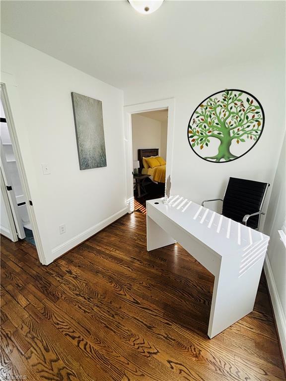 corridor with dark wood-type flooring