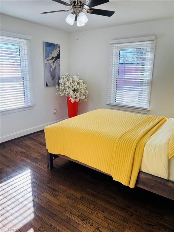 bedroom with ceiling fan and dark hardwood / wood-style flooring