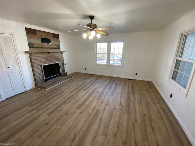 unfurnished living room with ceiling fan, hardwood / wood-style floors, and a fireplace