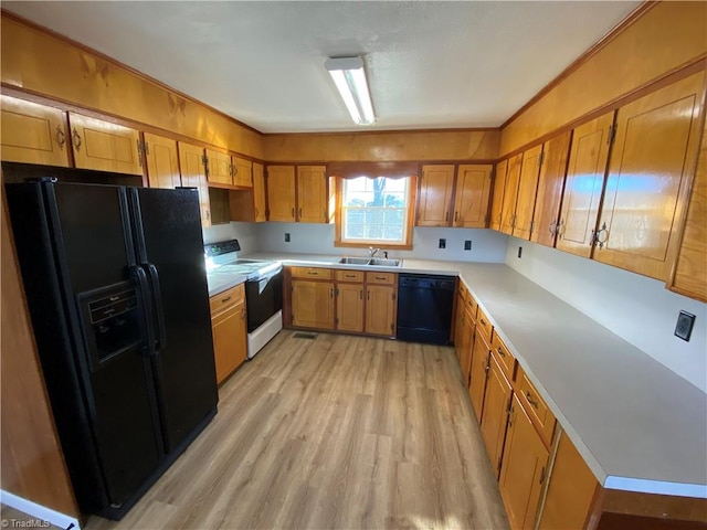 kitchen with ornamental molding, light hardwood / wood-style floors, sink, and black appliances