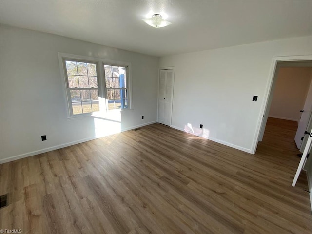 empty room featuring dark hardwood / wood-style flooring