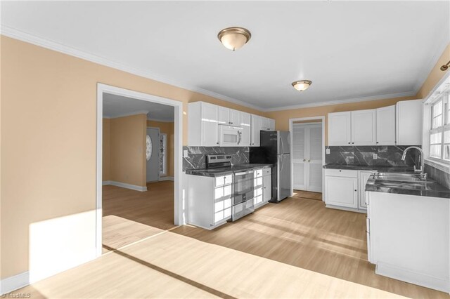 3227 Loftyview Dr, High Point, NC 27260 - kitchen with a sink, appliances with stainless steel finishes, backsplash, and dark countertops