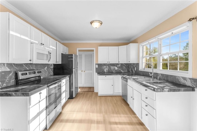 3227 Loftyview Dr, High Point, NC 27260 - kitchen featuring stainless steel appliances, dark countertops, white cabinetry, and a sink
