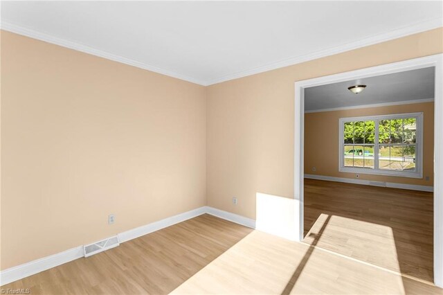 3227 Loftyview Dr, High Point, NC 27260 - spare room with visible vents, baseboards, crown molding, and wood finished floors