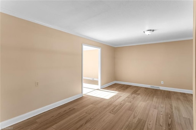 3227 Loftyview Dr, High Point, NC 27260 - spare room featuring baseboards, visible vents, ornamental molding, and light wood-type flooring