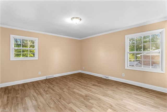 3227 Loftyview Dr, High Point, NC 27260 - spare room featuring crown molding, baseboards, plenty of natural light, and light wood finished floors
