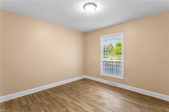 3227 Loftyview Dr, High Point, NC 27260 - spare room featuring baseboards, wood finished floors, and visible vents