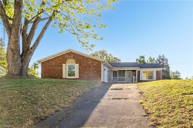 3227 Loftyview Dr, High Point, NC 27260 - ranch-style home with brick siding, a front yard, and aphalt driveway