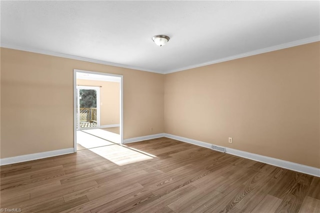 3227 Loftyview Dr, High Point, NC 27260 - spare room featuring baseboards, ornamental molding, and wood finished floors