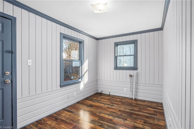 unfurnished room with dark hardwood / wood-style floors and ornamental molding