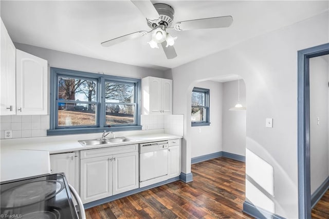 kitchen with dishwasher, white cabinetry, dark hardwood / wood-style flooring, and tasteful backsplash