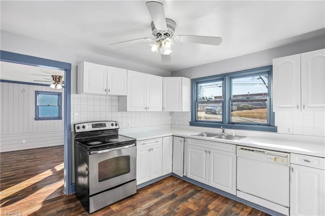 kitchen with sink, white cabinets, white dishwasher, and electric stove