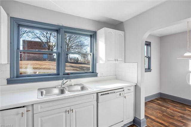 kitchen with white dishwasher, sink, white cabinets, tasteful backsplash, and plenty of natural light