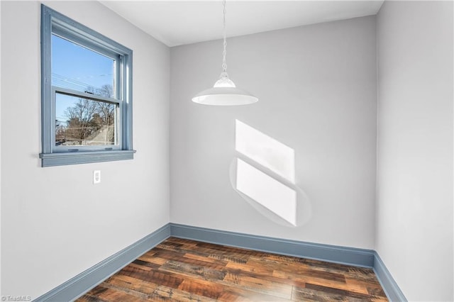 spare room with dark hardwood / wood-style flooring