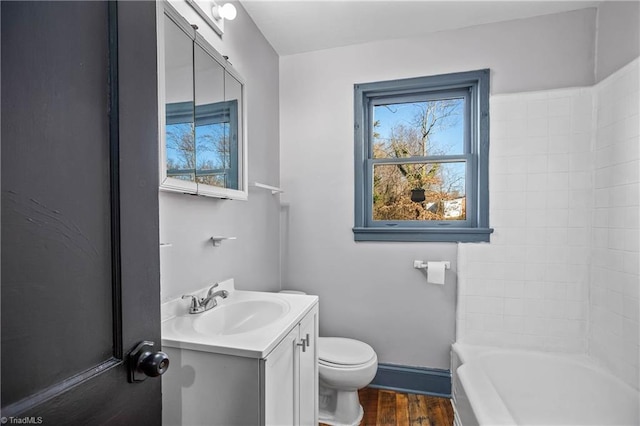 bathroom featuring hardwood / wood-style floors, toilet, and vanity