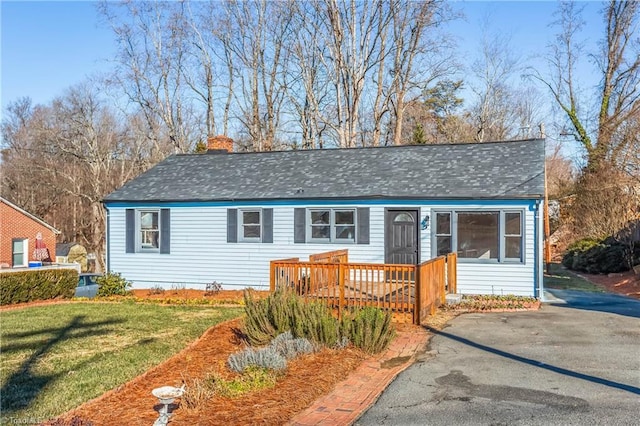 view of front of house featuring a front yard and a deck