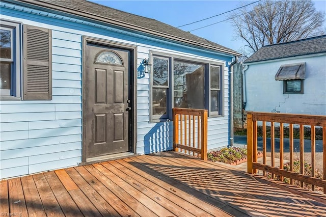 view of exterior entry with a deck