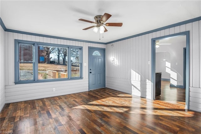 foyer entrance with ceiling fan, dark hardwood / wood-style flooring, and ornamental molding