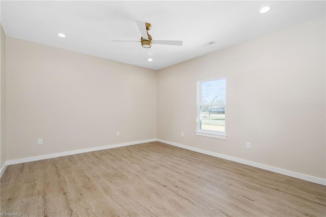 empty room with light wood-style floors, baseboards, visible vents, and recessed lighting