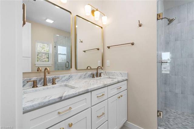 bathroom featuring a sink, double vanity, and a stall shower