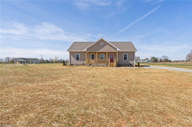 ranch-style house featuring crawl space, covered porch, and a front lawn