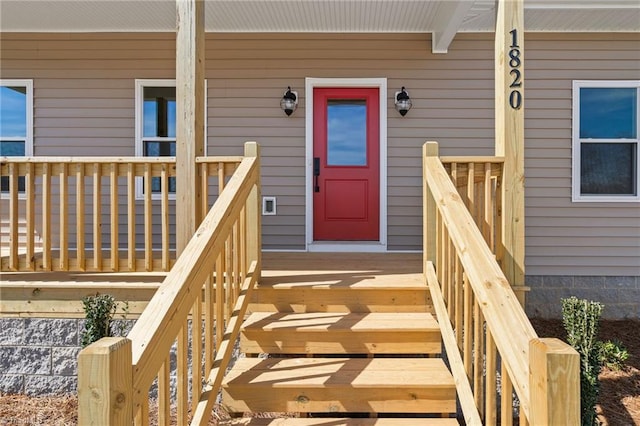 view of exterior entry with covered porch