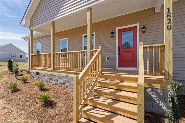 view of exterior entry with a porch