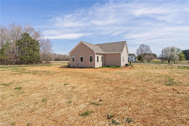view of side of home with a lawn