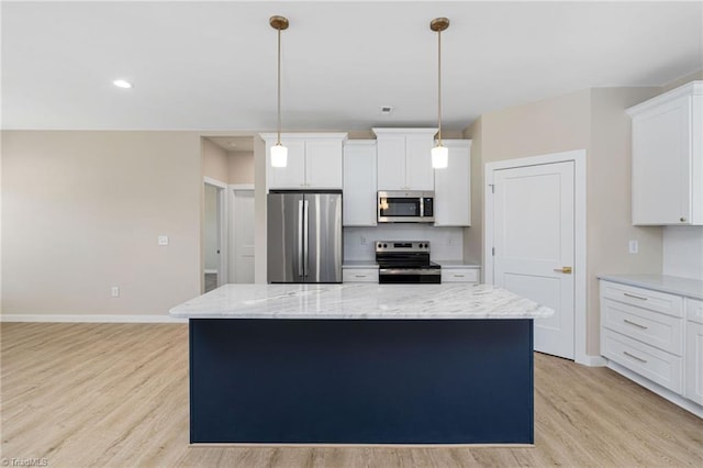 kitchen with tasteful backsplash, light stone counters, a center island, appliances with stainless steel finishes, and light wood finished floors