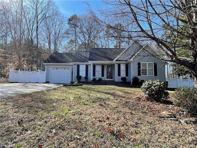 view of front of property with a garage, driveway, a front yard, and fence