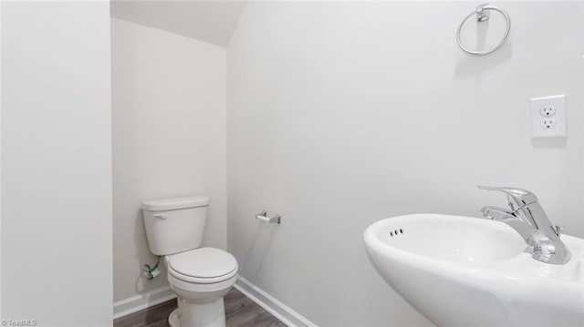 bathroom featuring sink, hardwood / wood-style flooring, and toilet