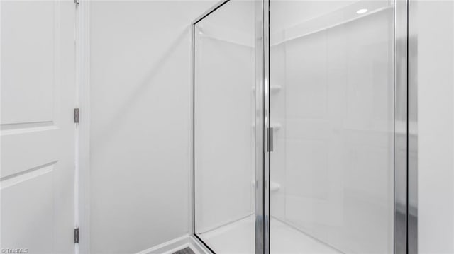 bathroom with a shower with shower door