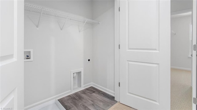 washroom with washer hookup, hookup for an electric dryer, and hardwood / wood-style flooring