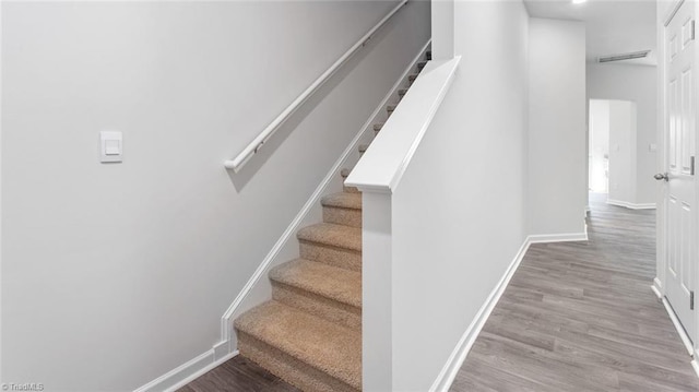 stairs with hardwood / wood-style floors