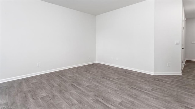 empty room with hardwood / wood-style floors