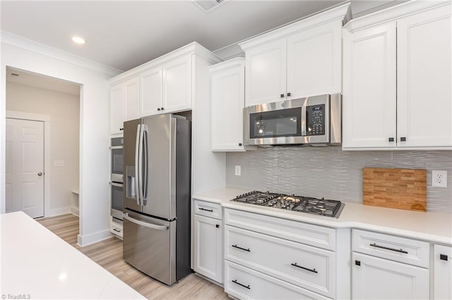 1515 Peabody Ct, Mebane, NC 27302 - kitchen with appliances with stainless steel finishes, light countertops, white cabinets, recessed lighting, and crown molding